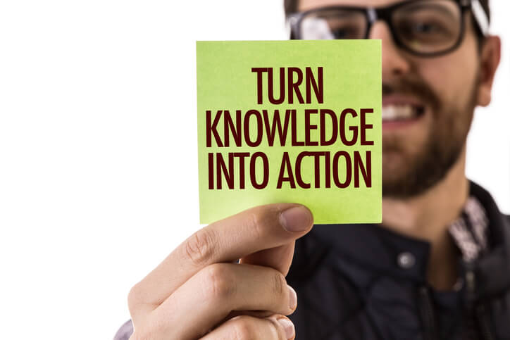 man holding sticky note turn knowledge into action