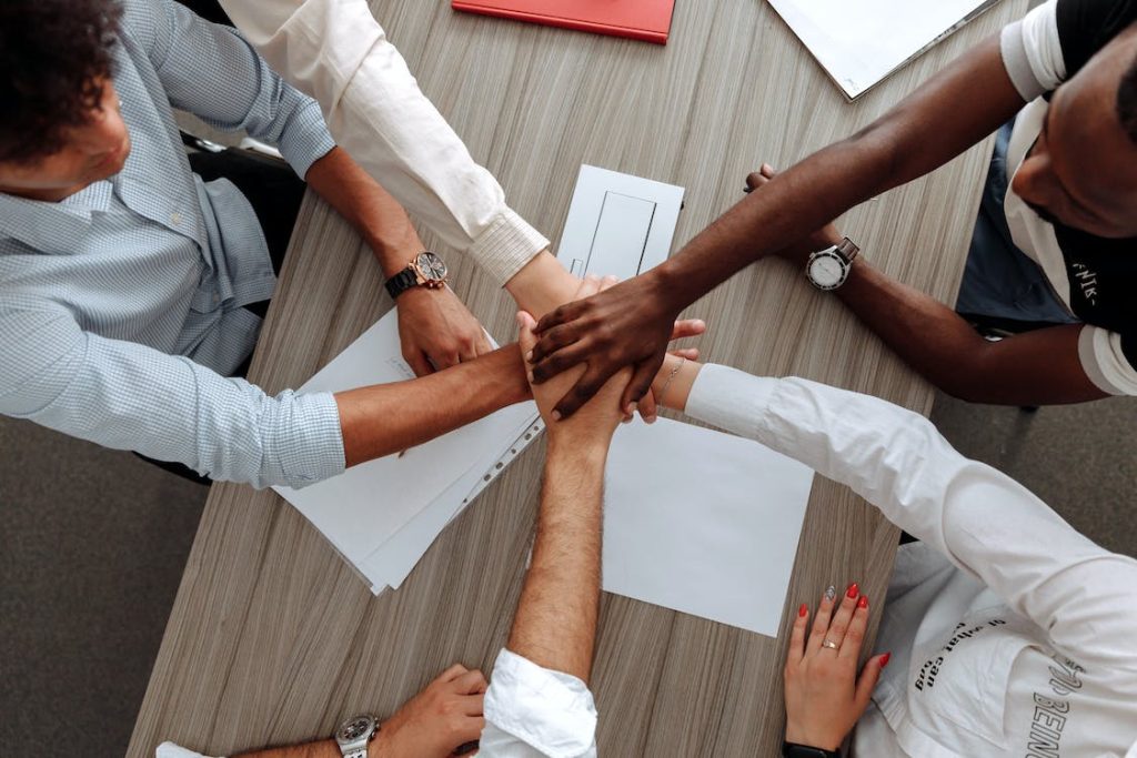 coworkers with hands together