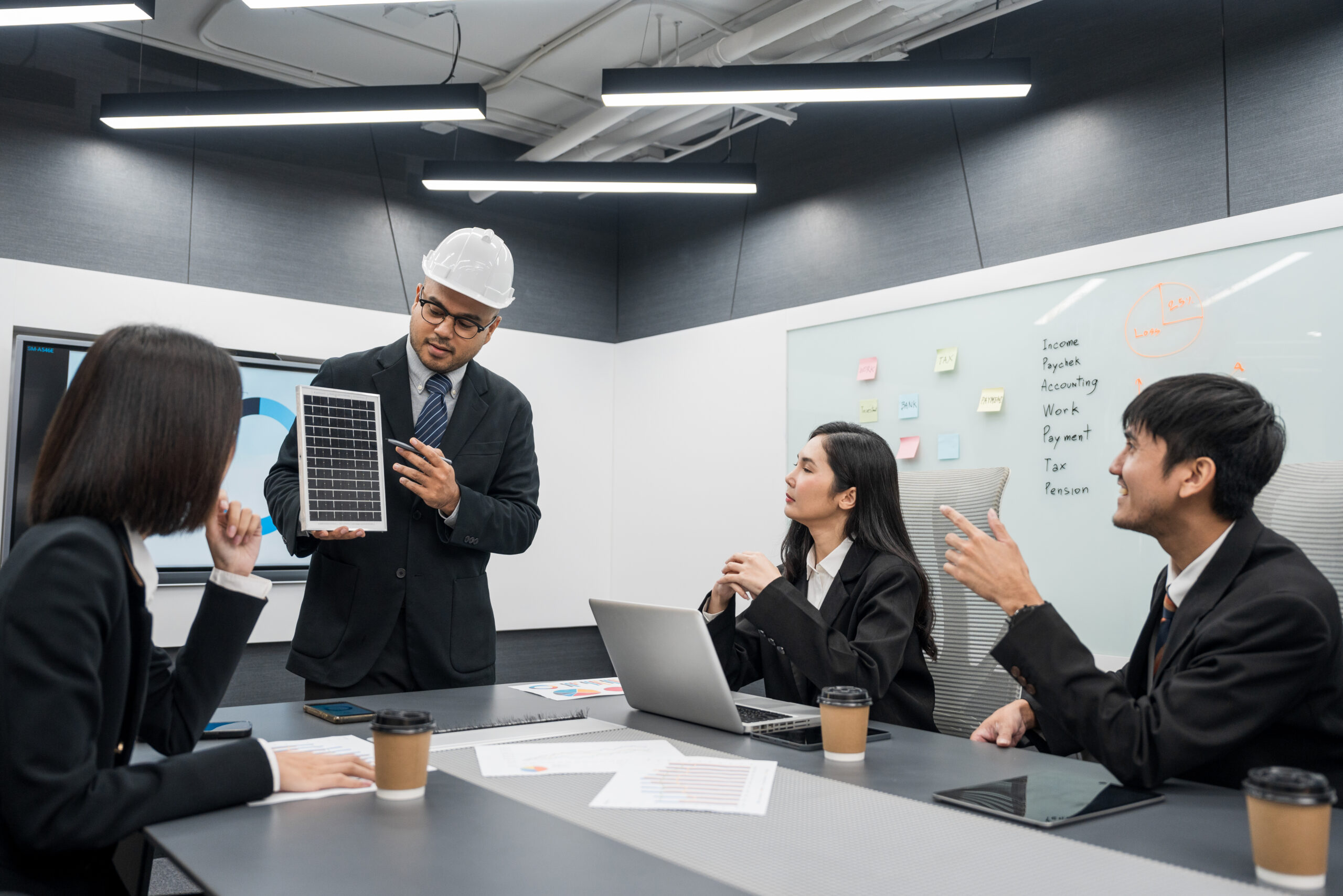 Business team meeting discuss of renewable energy working on an innovative more efficient solar cell panel battery. Solar generator power Generating electricity clean energy